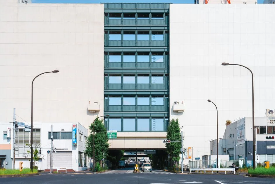an empty street with a tall building in the background